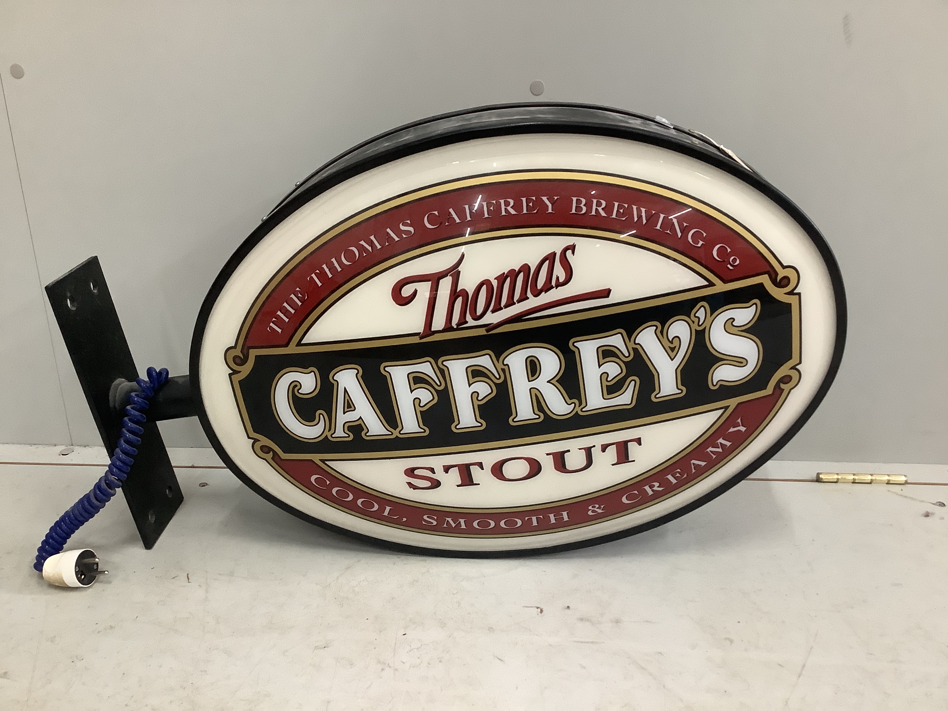 A Caffrey's illuminated double sided pub sign, width with bracket 75cm, height 46cm